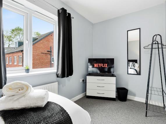 Bedroom styled in soft grey with monochrome accents