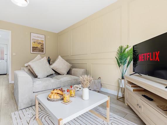 Living room styled with panelled walls and cream sofa